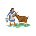 Cute farmer woman in blue dress is feed goat Royalty Free Stock Photo