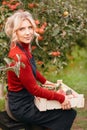 Cute farmer woman with freshly harvested apples in wooden box. Agriculture and gardening