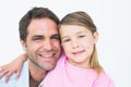 Cute father and daughter posing and smiling at camera together