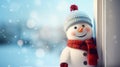 Cute felt toy snowman in a knitted blue hat and red scarf