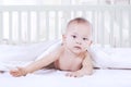 Cute female baby lying on bed