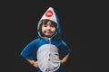 Child portrait with baby shark costume in studio