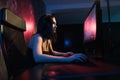 A cute female gamer girl sits in a cozy room behind a computer and plays games. Woman live streaming computer video Royalty Free Stock Photo