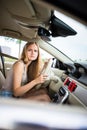 Cute female teen driver enjoying her freshly acquired driving license