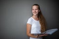 Cute female student with books in library Royalty Free Stock Photo