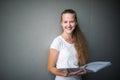 Cute female  student with books in library Royalty Free Stock Photo