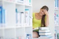 Cute female universit student with books in library Royalty Free Stock Photo