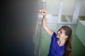 Cute female university/highschool student in front of a blackboard Royalty Free Stock Photo