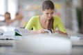 Cute female universit student with books in library Royalty Free Stock Photo