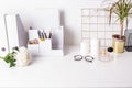 Cute feminine stuff on white table with glasses and flower, office background