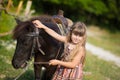 Cute fermer beautiful girl cowboy in jeans enjoying summer day in village life with flowers wearing leather cow hat happyly smilin Royalty Free Stock Photo