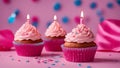 A cute and festive photo of a pink birthday cupcake with a one 1 single candle on top of each 3 three candles Royalty Free Stock Photo