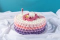 Cute festive pink cake decorated with a big flower where sleeps the little Princess. Desserts for a birthday