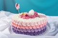 Cute festive pink cake decorated with a big flower where sleeps the little Princess. Desserts for a birthday