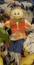 cute festive scarecrow smiling doll in cart