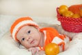 Cute few days newborn baby with funny curious face dressed in a Royalty Free Stock Photo