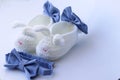 Cute first white baby booties with bows and little blue bow tie