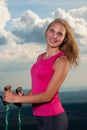 Cute fit woman hiking with evening sky in the background