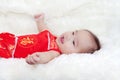 Cute five months asian baby smiling in red cheongsam