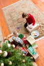 Cute five year old girl wrapping a Christmas gift