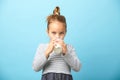 Cute five years old girl drinks milk on blue isolated.