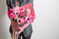 Cute flowers. beautiful bouquet of pink anemones in woman hand. the work of the florist at a flower shop. A small family