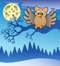 Cute flying owl in snowy landscape