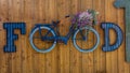 Cute Food, Bicycle and Flowers sign in front of restaurant in Norwood,. Store, House