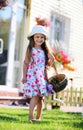 Cute four-year girl carrying a basket