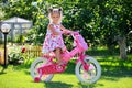 Cute four-year old girl riding her bicycle