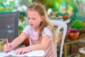 Cute freckles child drawing outdoor.