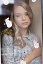 Cute freckles girl behind window Royalty Free Stock Photo