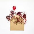 Cute fresh berries and leaves in an envelop on white background. Stylish flat lay. Minimal concept