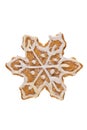 Cute fresh gingerbread snowflake decorated with royal icing, isolated on white background. Christmas food, pastry background. New