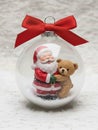 Santa and bear hug inside globe bauble. Royalty Free Stock Photo