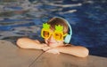 Cute fun kid face of little boy in funny sunglasses in pool in sunny day. Royalty Free Stock Photo