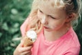 Cute funny adorable girl with dirty nose and milk moustaches eating licking ice cream from waffle cone. Child eating tasty sweet Royalty Free Stock Photo