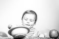 Cute funny babies eating, baby food. Funny kid boy with plate and spoon. Royalty Free Stock Photo