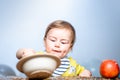 Cute funny babies eating, baby food. Funny kid boy with plate and spoon. Royalty Free Stock Photo