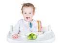 Cute funny baby eating broccoli Royalty Free Stock Photo