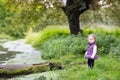 Cute funny baby girl at river shore on cold day Royalty Free Stock Photo