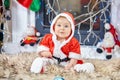 Cute little baby in Santa Claus clothes