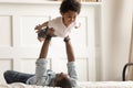 Cute funny black boy flying in strong fathers hands. Royalty Free Stock Photo