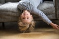 Kid boy lying upside down on sofa looking at camera Royalty Free Stock Photo