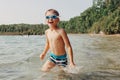 Cute funny Caucasian boy swimming in lake with underwater goggles. Child diving in water on a beach. Authentic real lifestyle Royalty Free Stock Photo