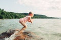 Cute funny Caucasian girl diving in lake with underwater goggles. Child divinswimming in water on a beach. Authentic real Royalty Free Stock Photo