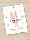 Cute funny Easter Bunny with lettering Happy Easter. Painted Easter eggs and stars around it. A hand-drawn hare by a child. Royalty Free Stock Photo