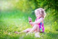 Cute funny girl eating ice cream in sunny garden Royalty Free Stock Photo