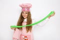 Cute funny girl with slime in the kitchen. The girl cooks and bakes her muffins, makes a cake and slime. Royalty Free Stock Photo