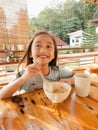 Cute funny kid eating cereal for breakfast..Little girl have a meal.  Happy preschooler lifestyle portrait Royalty Free Stock Photo